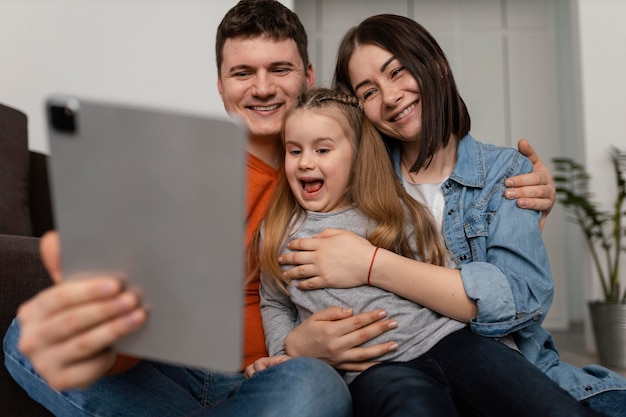 Medium shot happy family with laptop