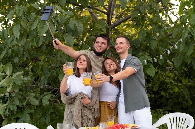 Medium shot happy friends taking selfie