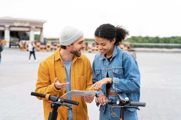 Free photo medium shot happy friends with scooters