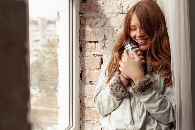 Medium shot happy girl with flask