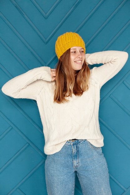 Free photo medium shot happy girl with yellow hat posing