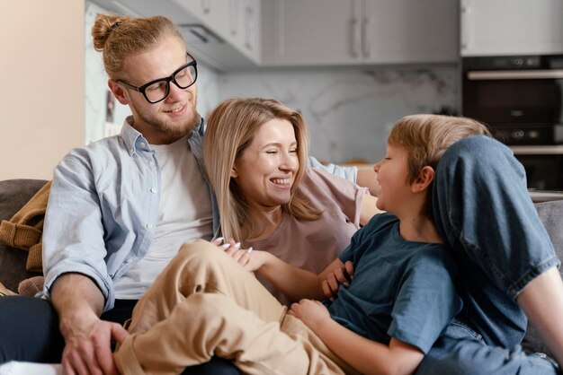 Medium shot happy kid and parents