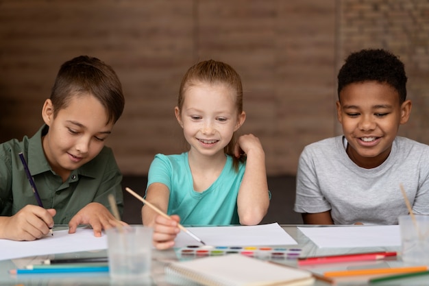 Medium shot happy kids painting