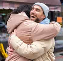 Free photo medium shot happy man hugging woman