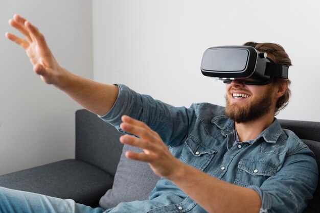 Medium shot happy man with vr glasses