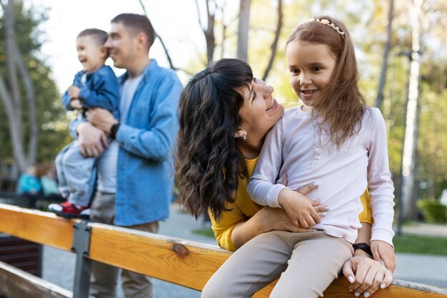 Medium shot happy parents with kids