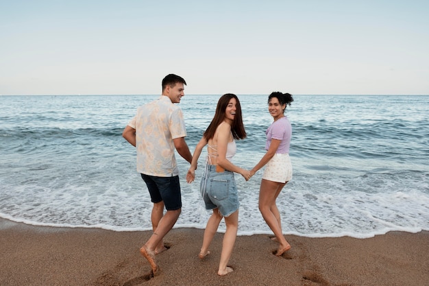 Medium shot  happy people at beach