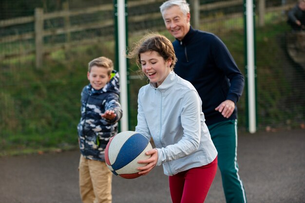 Medium shot happy people with ball