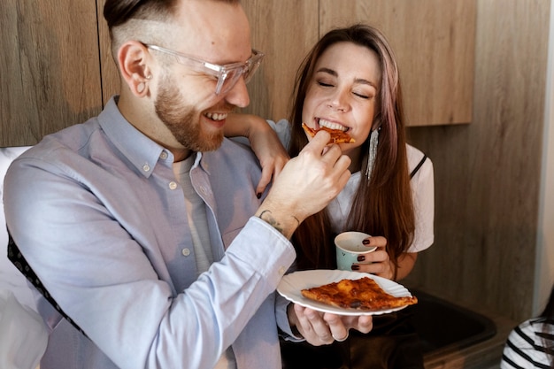 Medium shot happy people with pizza