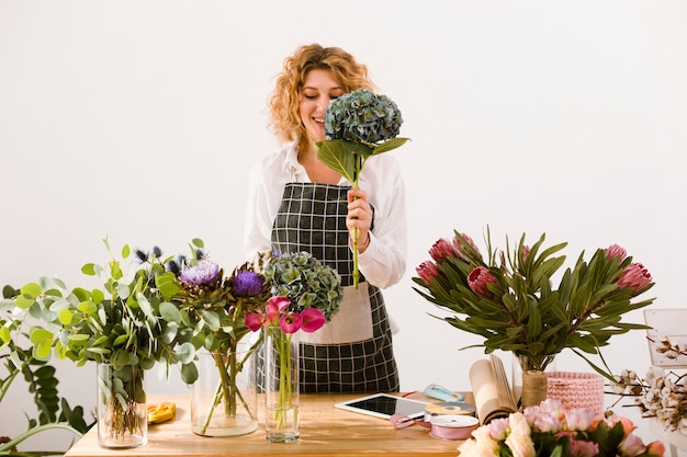 Medium shot happy woman holding a bouquet