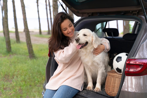 Free Photo medium shot happy woman holding dog