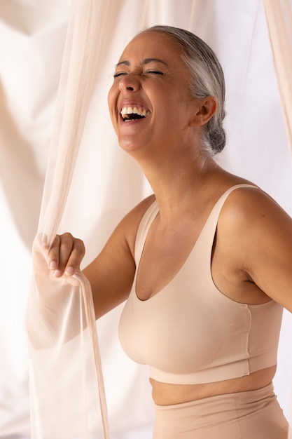 Medium shot happy woman posing in studio