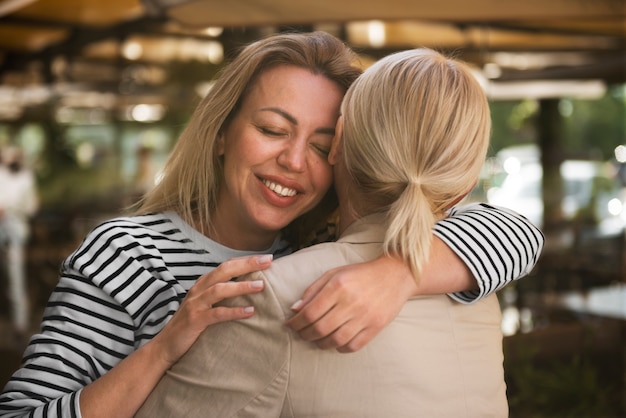 Free Photo medium shot happy women hugging