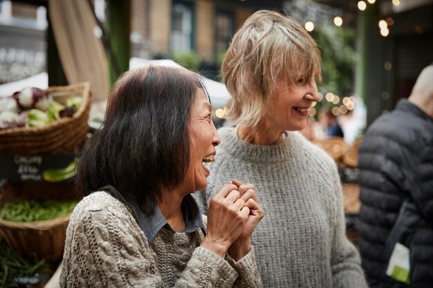 Medium shot happy women at store