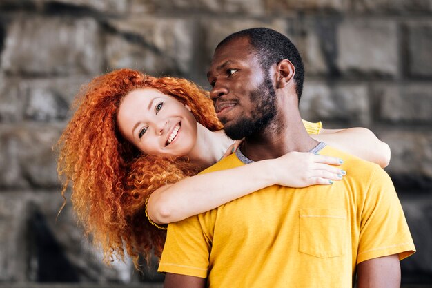 Medium shot of interracial couple smiling