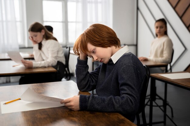 Medium shot kid cheating at school test