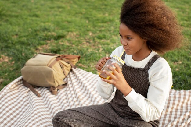 Medium shot kid drinking juice