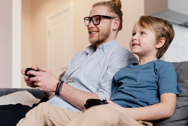 Medium shot kid and father playing