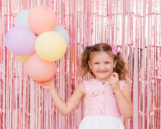 Medium shot kid holding balloons