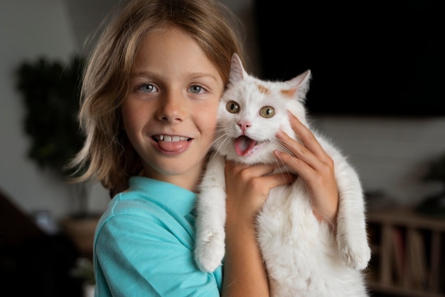 Medium shot kid holding cat