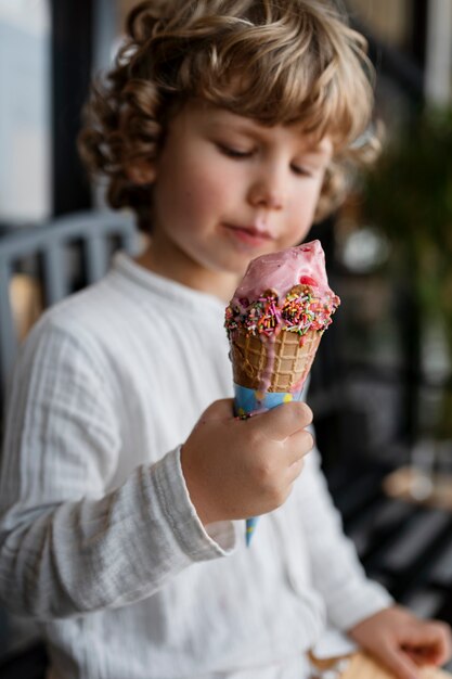 Medium shot kid holding ice cream cone