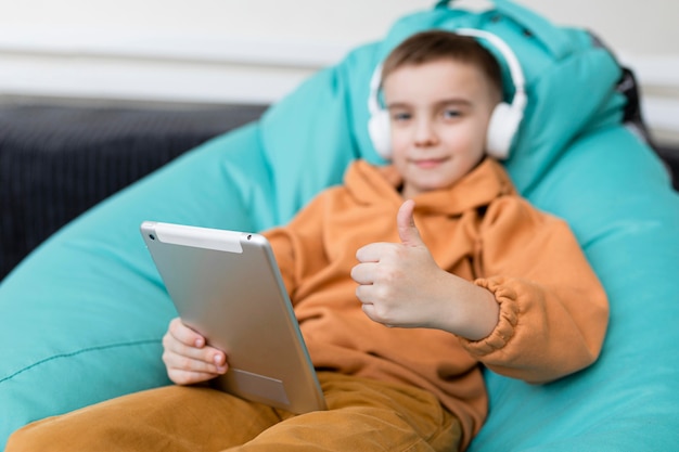 Medium shot kid holding tablet