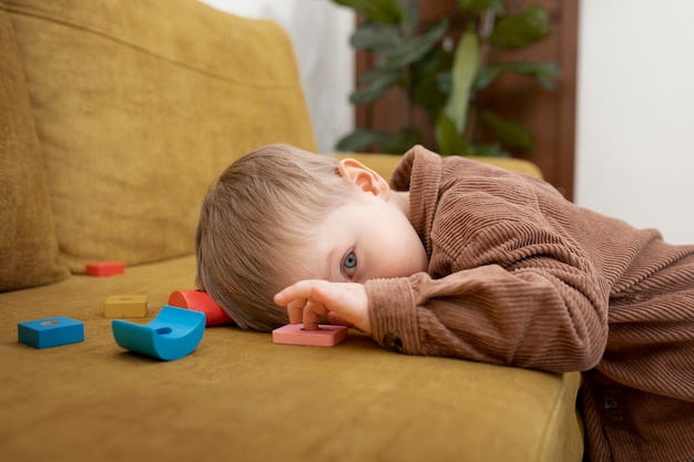 Medium shot kid laying on couch