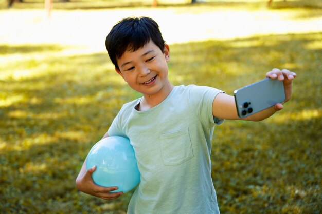 Medium shot kid posing with ball