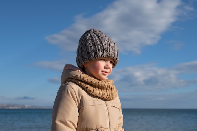 Medium shot kid at seaside in winter