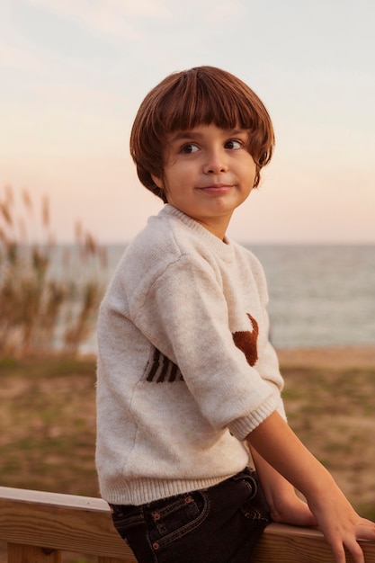 Medium shot kid sitting on fence