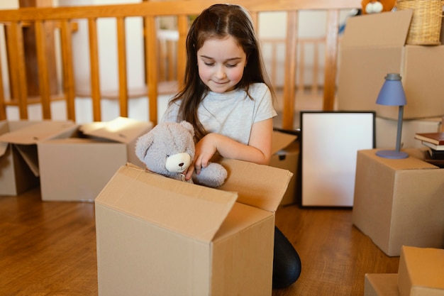 Medium shot kid sitting on floor with toy