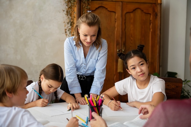 Medium shot kids drawing at table