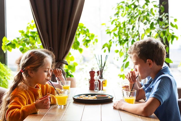 Medium shot kids drinking juice