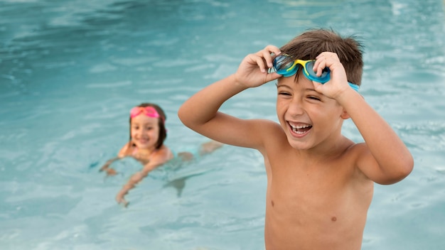 Medium shot kids having fun at pool