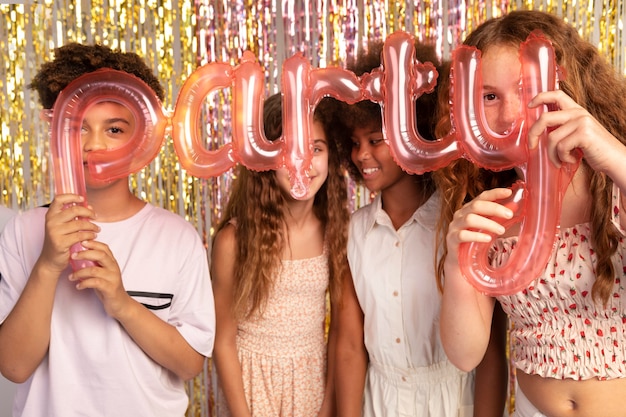 Medium shot kids holding balloons