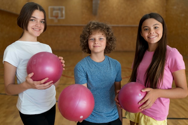 Medium shot kids holding balls