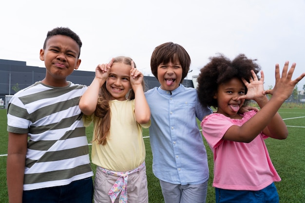 Free Photo medium shot kids making funny faces