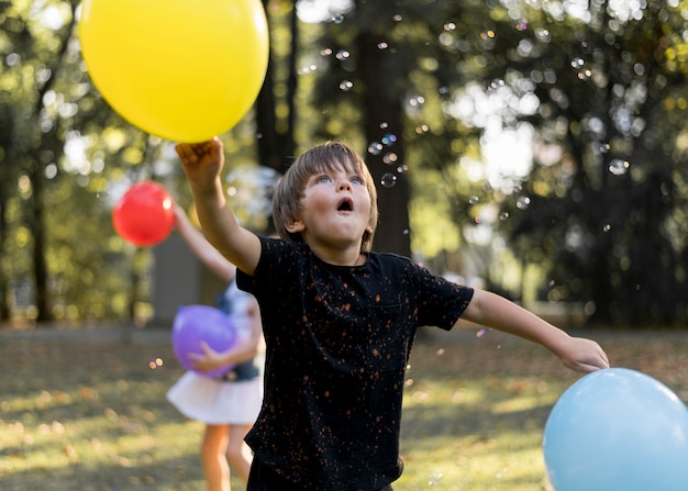 Medium shot kids playing outdoors