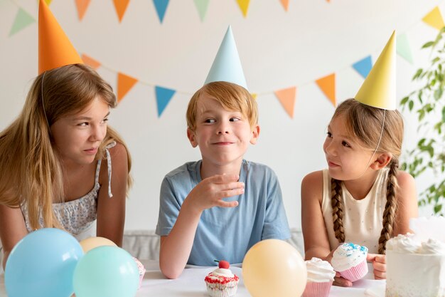 Medium shot kids wearing party hats