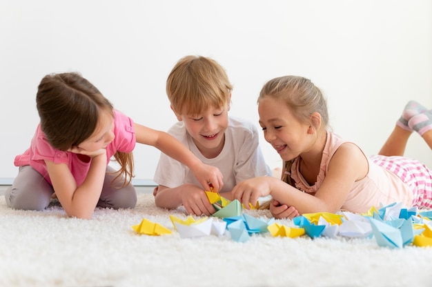 Free Photo medium shot kids with paper boats