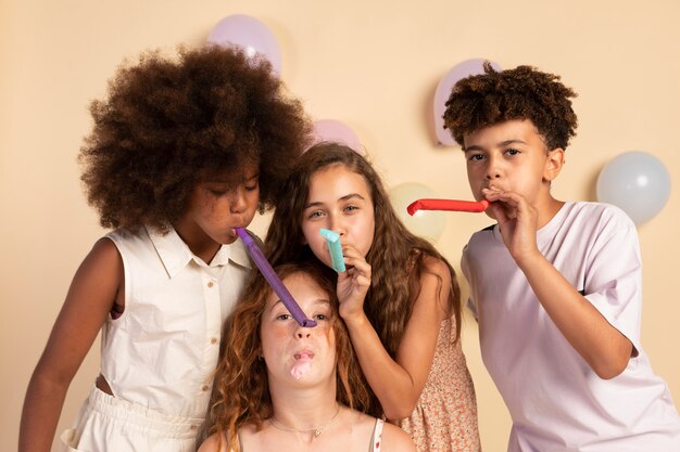 Medium shot  kids with party whistles