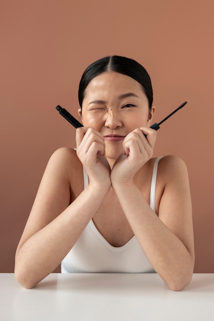 Medium shot korean woman holding mascara