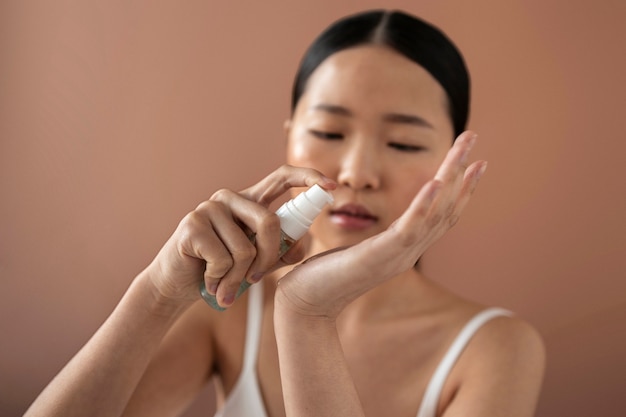 Medium shot korean woman posing with serum