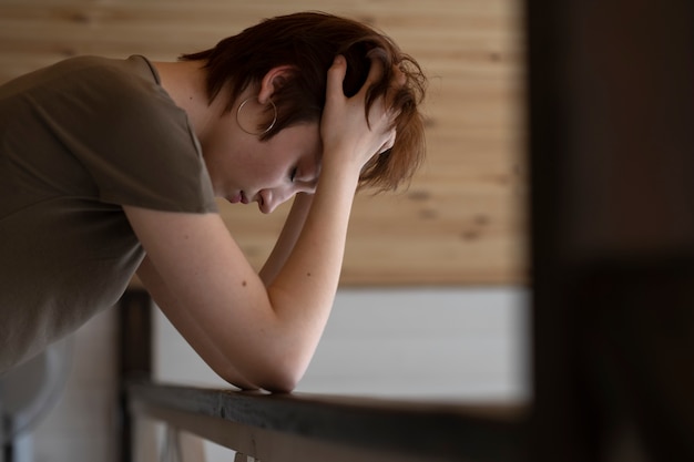 Medium shot lonely woman at home