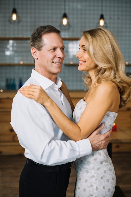 Medium shot of lovely married couple dancing 