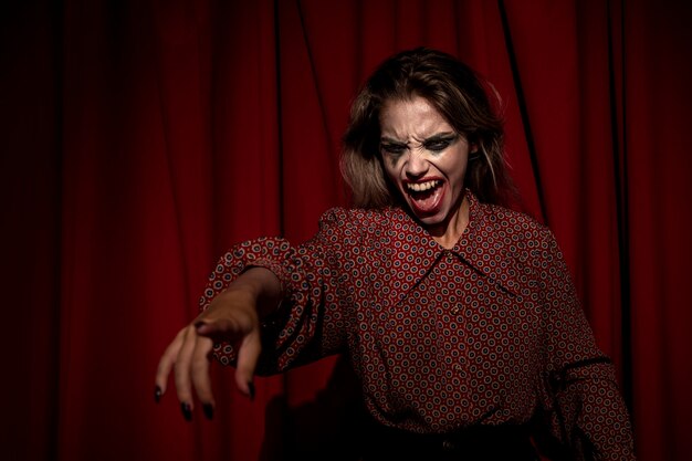 Medium shot of make-up woman clown pointing with her finger