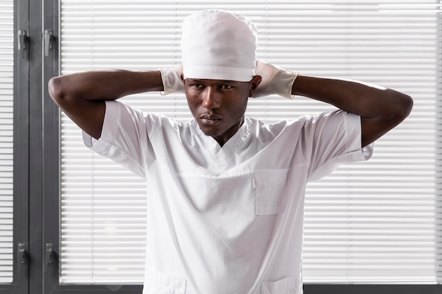 Medium shot of male doctor wearing white clothes