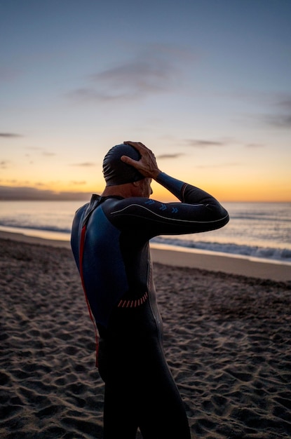 Medium shot man on beach at sunset