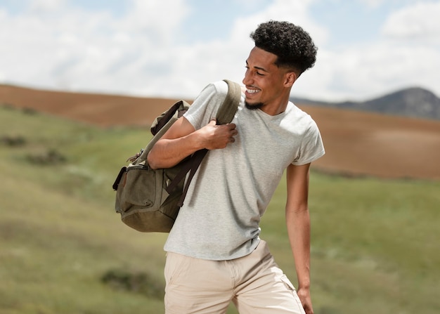 Medium shot man carrying backpack