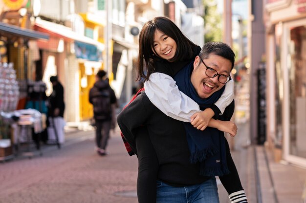 Medium shot man carrying daughter